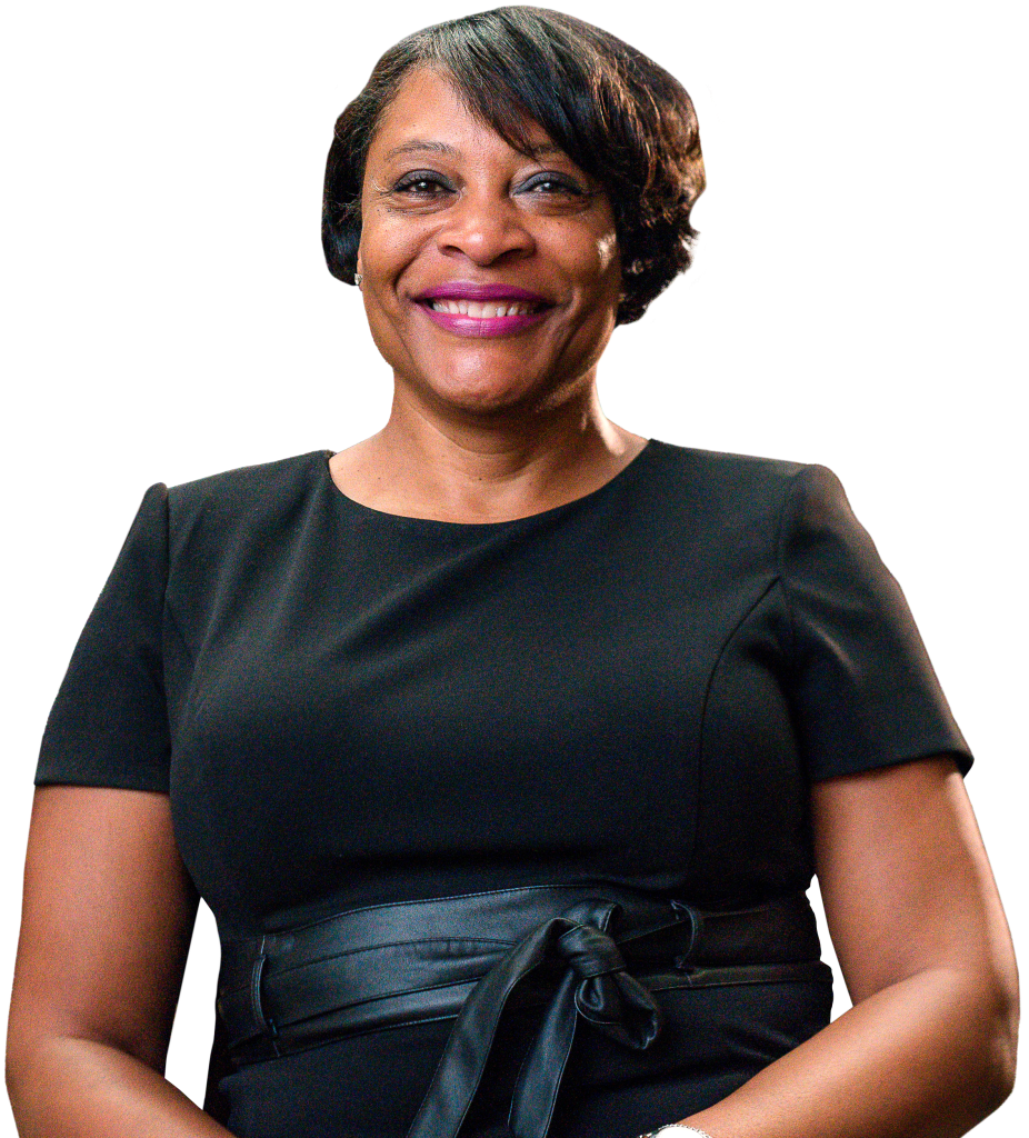 Portrait of Eureka People, Executive Director of Housing Kent, smiling in front of a colorful geometric background.